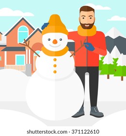 Man posing near snowman.