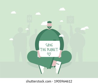 A man with a poster supporting the concept of sustainable living. Save the planet. Go green.