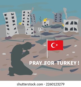 Un hombre rezando contra el fondo de las casas destruidas luego del terremoto en Turquía.
