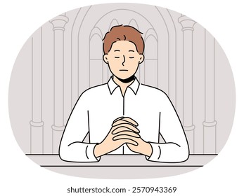 Man praying sitting on bench in temple seeking spiritual support in catholic and christian religion. Guy closes eyes and praying standing in orthodox cathedral and needs help of lord