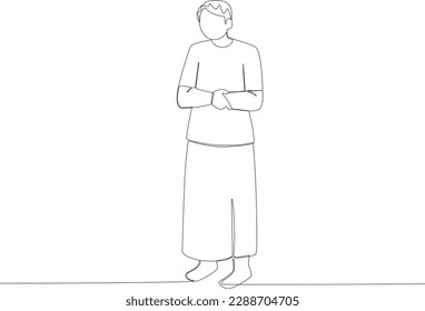 A man praying stands folding his hands