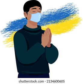 A man prays on the background of a stylized flag. Solidarity with Ukraine. Prayer for the peace
