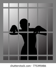 Man in prison or dark dungeon behind bars 