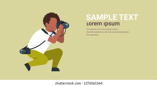 man professional photographer taking photo african american guy journalists or paparazzi taking photos using dslr camera horizontal full length flat copy space