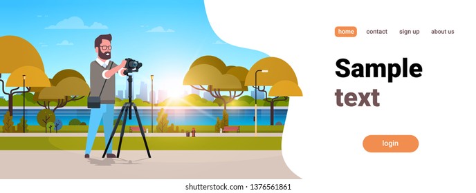 man professional photographer taking photo guy using dslr camera on tripod city urban park landscape background horizontal full length flat copy space