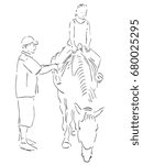 The man pulls up the girths of the horse. The little girl is sitting on horseback and looking at the groom