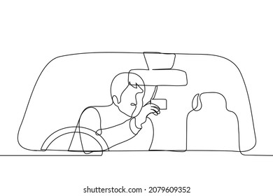 man pulls out the right from the sun visor - one line drawing vector. driver in the right hand drive car is holding his license