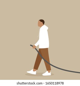 A man pulls a rope or hose