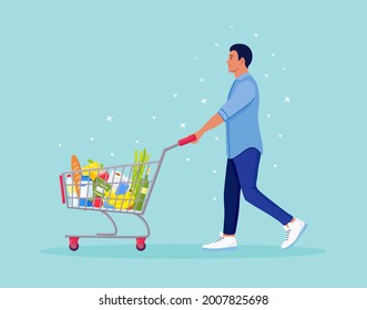 Man pushing shopping cart full of groceries in the supermarket. There is a bread, bottles of water, milk, fruits, vegetables and other products in the basket. Vector illustration