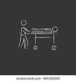 Man pushing stretchers. Drawn in chalk icon.