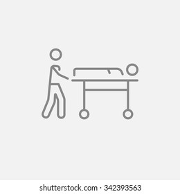 Man pushing stretchers with patient line icon for web, mobile and infographics. Vector dark grey icon isolated on light grey background.