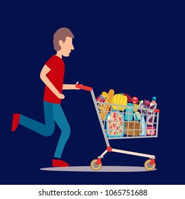 A Man pushing supermarket shopping cart full of groceries. Shopping cart full of groceries products