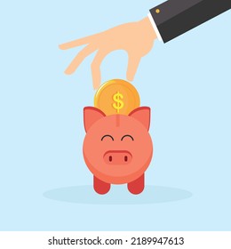 A man puts a coin in a piggy bank. The topic of savings.