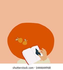 Man read the a book inside which space. Oranges on a wooden table