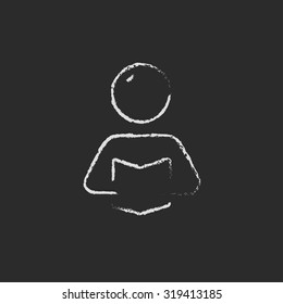 Man reading a book hand drawn in chalk on a blackboard vector white icon isolated on a black background.