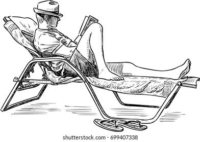 A man reads a book on the seashore