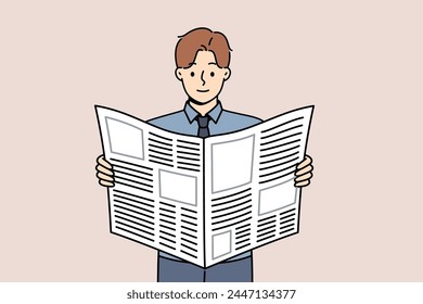 Man reads business newspaper to learn about news from large corporations or looks for job advertisements. Guy with daily newspaper scours press for inside information about company vacancies.