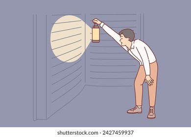 Man reads giant book with interest, holding lantern to illuminate encyclopedia at night. Guy found fantastic book with secret information curiously studies literature with important facts.