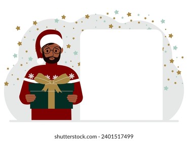 Un hombre con un suéter rojo sostiene una gran caja de regalo con un arco. Año Nuevo o Navidad.