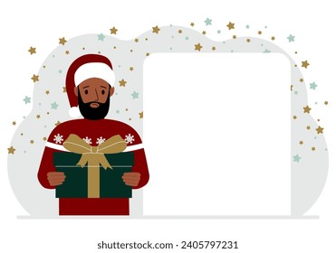 A man in a red sweater is holding a large gift box with a bow. New Year or Christmas.