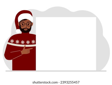 A man in a red sweater near a large white sheet. Advertising, invitation, discount for Christmas or New Year.