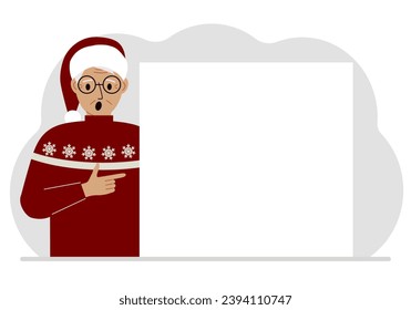 A man in a red sweater near a large white sheet. Advertising, invitation, discount for Christmas or New Year.