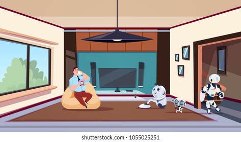 Man Relaxing In Living Room While Group Of Robots Housekeepers Clean House