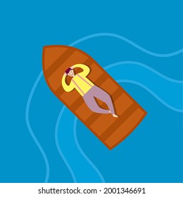 The man relaxing lying on a boat in the sea. Relaxing day in summer concept.