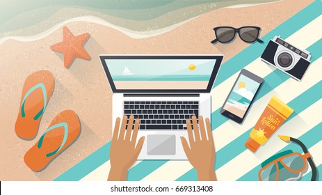 Man relaxing on the beach and connecting with his laptop next to the sea water, top view