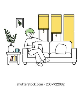 A man relaxing in the room and looking at a tablet