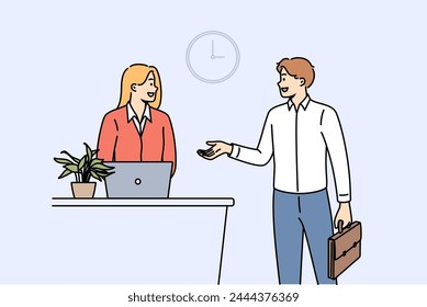 Man rents hotel room talking to administrator standing near reception desk with laptop. Successful businessman checks into hotel during corporate trip to attend professional seminar.