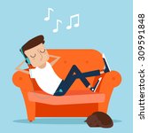 Man resting at home. Laying on sofa and listening music