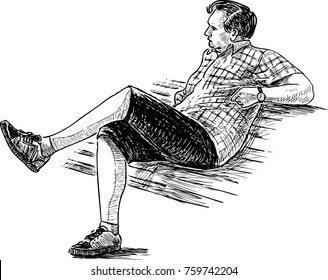 A man is resting on a park bench