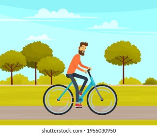 Man rides bicycle on sandy road in forest. Sportsman cycling on background of park landscape