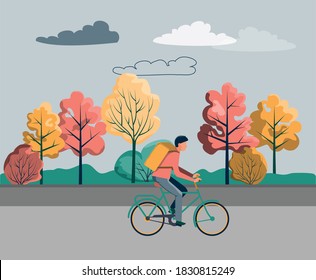 A man is riding a bicycle on an autumn street. The concept of food delivery