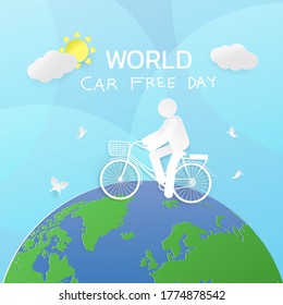 A man riding a bicycle on the earth withe hand writing text world car free day .save nature