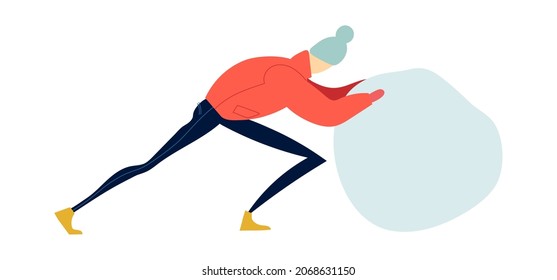 A man rolls a ball out of the snow