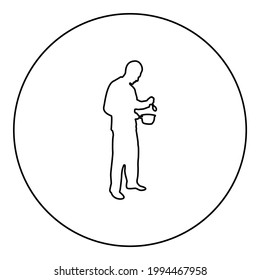 Man with saucepan spoon in his hands preparing food Male cooking use sauciers silhouette in circle round black color vector illustration contour outline style image 