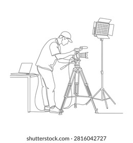 Man setting up camera on tripod with softbox light for photography