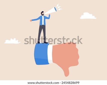 A man in a sharp suit stands with a defiant gesture, holding a loudspeaker and showing a thumbs-down. His expression conveys firm decision-making, reflecting a provocative marketing strategy.