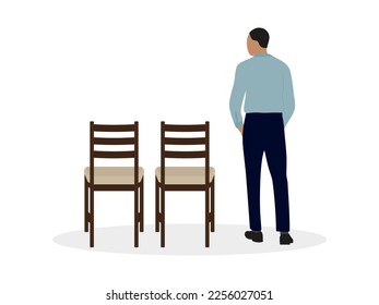 A man in a shirt stands near two chairs on a white background