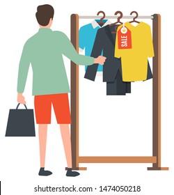 Man shopping vector, male holding bag in hands flat style, client choosing clothes. Store with clothing, sale on shirts and jackets, discounts promotion