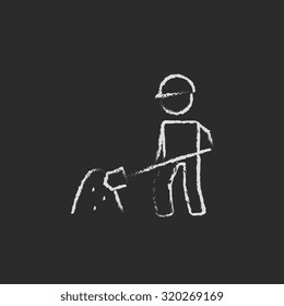 Man with shovel and sand hand drawn in chalk on a blackboard vector white icon isolated on a black background.