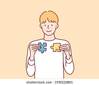 man showing jigsaw puzzle. Hand drawn style vector design illustrations.