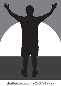 A man in silhouette with arms raised is greeting the rising sun