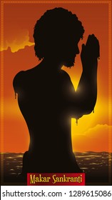 Man silhouette bathing and praying to Indian sun god Surya at the sunset in the Ganges -or Ganga- river during Makar Sankranti festival.