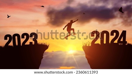 Man silhouette jumping on cliff 2023 over the precipice at amazing sunset. New Year's concept. Vector of starting and welcome happy new year 2024. People enters the year symbol 2024, creative idea.