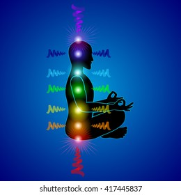 Man silhouette on the blue background with shining chakras