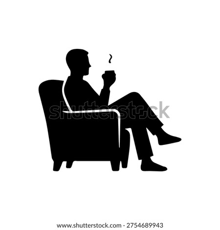 Man silhouette relaxing in an armchair, drinking a cup of coffee or tea