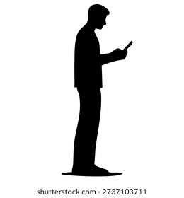 man silhouette standing and looking down at his mobile phone screen intently
